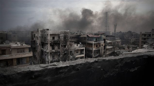 Smoke rises over Aaif Al Dawla district in Aleppo, Syria. Over the past four years, the country has been torn apart by factional fighting. In a dark, gloomy picture, we see thick, grey smoke hovering over bombed out, three-storey apartment houses.