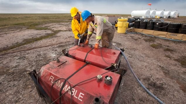 Two men working at the fuel storage site at the proposed Kiggavik uranium mine, near Baker Lake, Nunavut.  It may help supply uranium to India over the next five years.