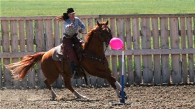 Christa Paterson in a tight turn and taking aim at a balloon target.