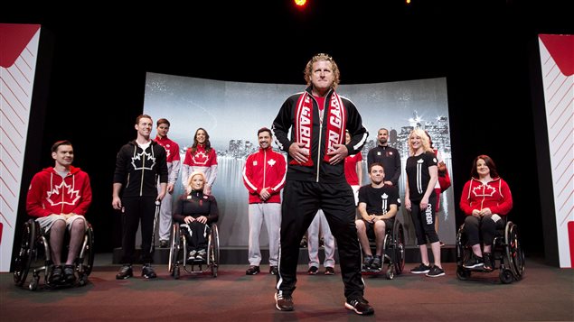 Former Olympian Curt Harnett, Canada's chef de mission, centre, and Canadian athletes model the Hudson's Bay Pan Am/Parapan Am Games official new team uniforms in Toronto on April 28, 2015