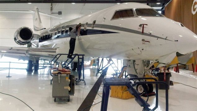 A Bombardier employee at work on a CS300 Aircraft in the hangar prior to its' test flight in Mirabel, Quebec, in February.