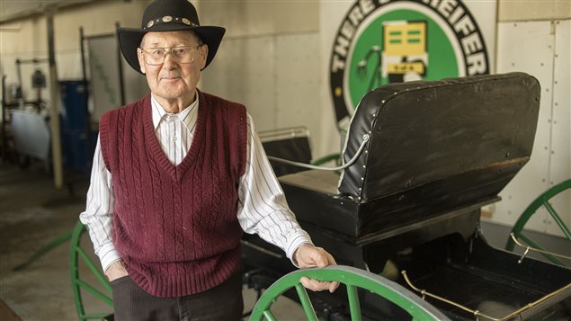   Jack Francis stands proudly beside the buggy he restored as part of the agricultural research museum associatied with the University of Alberta and the Faculty of Agricultural, Life and Environmental Sciences (ALES)
