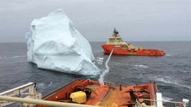 This photo captures the moments after a rope line was shot between the two vessels so they could move in tandem to guide the iceberg away.