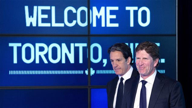 Toronto Maple Leafs president Brendan Shanahan, left, and new head coach Mike Babcock, arrive at the press conference in Toronto today.