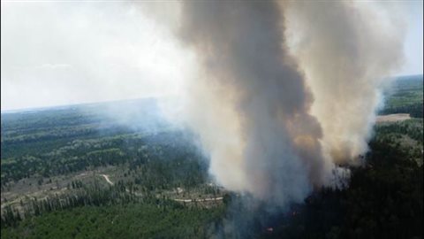Fire officials say a forest fire near Kenora is still smouldering, despite an aggressive attack. 