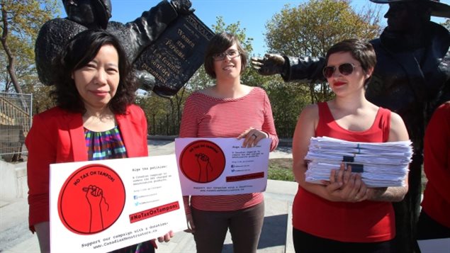 Lele Truong, Lareen Jervis and Mariana Hollmann, left to right, were on Parliament Hill earlier this month calling on the federal government to remove tax on feminine hygiene products. The government moved Thursday to lift the tax by July 1.
