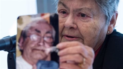 Lise Blais holds up a photograph of her husband, Jean-Yves Blais, who died from lung cancer after launching one of the two lawsuits, during a news conference on Monday in Montreal. She said he started smoking in the 1950's at age ten, and although he tried quitting several times, was unable to.