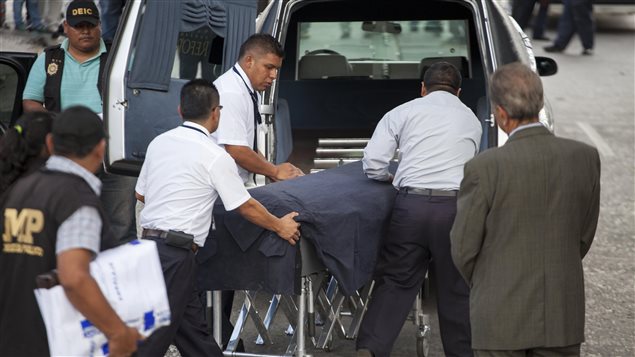 Empleados de una funeraria transportan el cadáver de Francisco Palomo en Ciudad de Guatemala. 