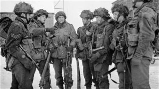 Paratroopers of the 1st Canadian Parachute Battalion preparing for a patrol, Bande, Belgium, 15 January 1945.  They carry a mix of weapons from the Tommy gun (left), the standard Lee-Enfield No4 rifle (next) to the Bren LMG (next) to the Sten (3rd from right)