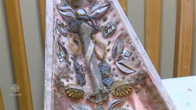 The middle portion of a reliquary and section of what appears to be a bone, possibly of some ancient Saint. The items found could be hundreds of years old