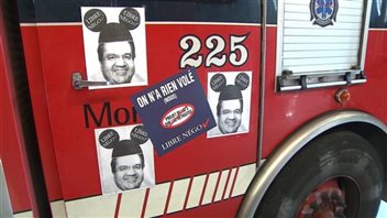 Firefighters applied stickers to their trucks to protest changes to their pension plans.