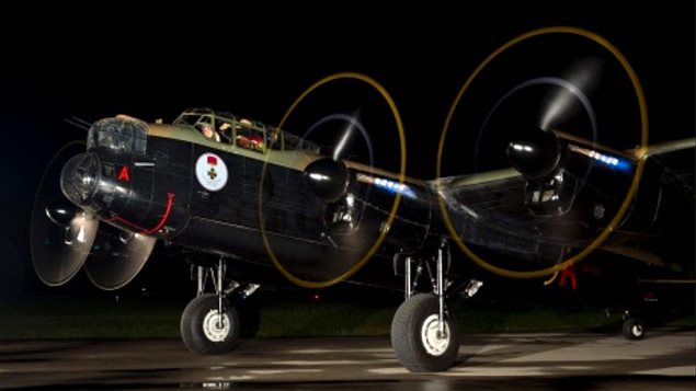 The Canadian Wartime Heritage Museum's Lancaster warming up at night.  Known as the Mynarski Lanc, V-RA "Vera" was restored as KB726, the same number as the plane Mynarski crewed on the night of June 12, 1944
