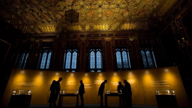 People looking over the four surviving original parchments of the Magna Carta, displayed to mark the 800th anniversary of its sealing at Runnymede in 1215, in the Queen's Robing Room at the Houses of Parliament in London, Feb. 5, 2015