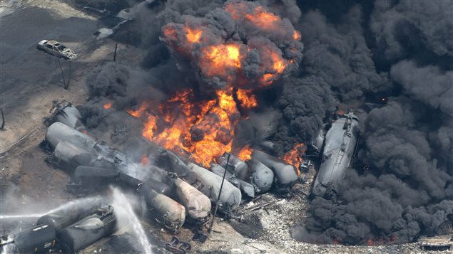 Smoke rises from railway cars that were carrying crude oil after derailing in downtown Lac-Megantic, Que., on July 6, 2013. 