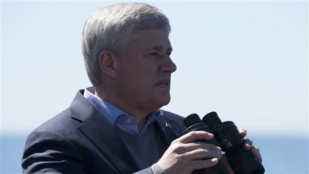 A new report says Prime Minister Stephen Harper's Conservatives should take another look at how they view opinions they disagree with. We see the prime minister on the bridge of ship holding a pair of binoculars as he looks out to sea.  
