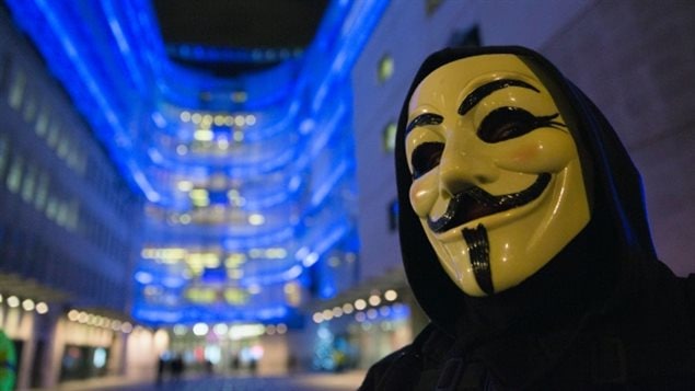  A supporter of the activist group Anonymous wears a mask during a protest in London in December 2014. The group has claimed responsibility for a cyber-attack today against the Canadian government in retaliation for passing Bill C-51