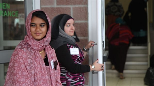 Volunteers greet visitors to Hamilton Mountain Mosque at the end of Ramadan in 2013. This year, the holy month coincides with graduation period so schools are finding creative ways to make sure fasting Muslim students are included.