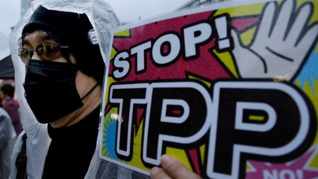 A Japanese protester rallies against the Trans-Pacific Partnership in Tokyo last year. A new poll suggests most Canadians are unaware of the major 12-country Asia-Pacific trade pact that Australia's trade minister said Wednesday is "literally one week of negotiation" away.
