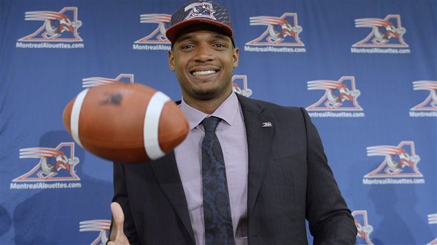 Michael Sam seemed more than ready to play football at his press conference in May. We see a smiling African-American man dressed in a classy, dark suit, blue shirt and tie under a blue Alouettes baseball cap bouncing a football with his right hand.