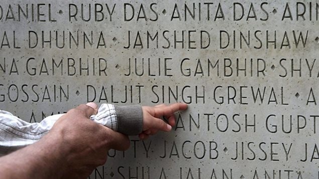 Jagit Grewal shows her two-year-old grandson Devin Grewal where her husband and his grandfather, Daljit Singh Grewal's name is on a monument honouring those who died, during a memorial marking the 25th anniversary of the Air India bombing in Vancouver, B.C., in 2010. 