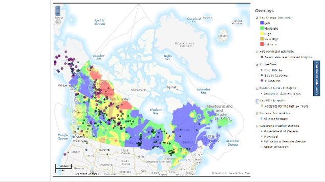 Canadian fire situation showing relative danger from blue(low) to red (extrme) and with dots showing various wildfires burning and relative size