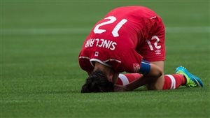 For Christine Sinclair, Canada's captain and star, the 2-1 loss to England in the quarter-finals was heartbreaking. We see Sinclair in her red sweater with the number 12 on her knees with her head bent over to the ground, obviously completely distraught.