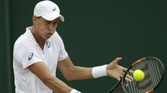 Vasek Pospisil was all business in his upset win over Viktor Troicki of Serbia Monday at Wimbledon. We see Pospisil dressed all in white with a white wrist band (it is Wimbledon, after all) watching intently as the ball goes off his racket on his backhand side. He is wearing a white baseball cap with the brim forward and has an extremely intense look on his face.