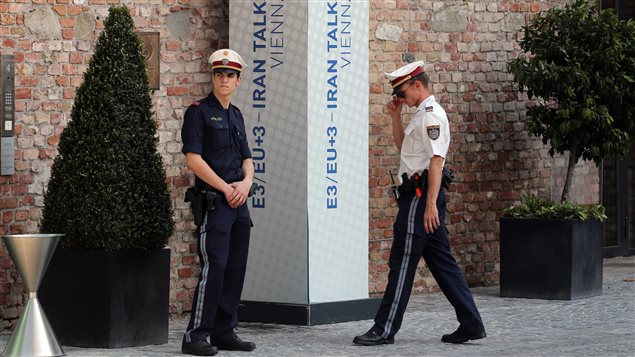 Police officers wait in front of the Palais Coburg where closed-door nuclear talks with Iran took place in Vienna, Austria, today. The talks went over their second deadline in a week, raising questions about whether world powers can cut off all pathways to an Iranian bomb through diplomacy — and testing the resolve of U.S. negotiators to walk away from negotiations.