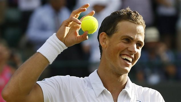 Vasek Pospisil celebrates his third-round victory over James Ward of Britain at Wimbledon on Saturday. We see Pospisil from his upper chest up. He is holding a yellow tennis ball in his right hand next to his right hear, as if about to throw it. He has a wide smile on his face. His dark blond hair is sweaty.