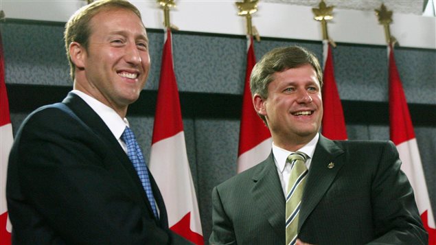 Les chefs du Parti progressiste conservateur, Peter MacKay, et de l’Alliance canadienne, Stephen Harper, se serrent la main après une conférence de presse au cours de laquelle ils ont annoncé la fusion de leurs deux partis, à Ottawa, le 16 octobre 2003.
