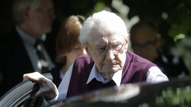 Former SS guard Oskar Groening enters a car after after the verdict of his trial in Lueneburg, Germany, Wednesday, July 15, 2015. Groening, 94, who served at the Auschwitz death camp was convicted on 300,000 counts of accessory to murder and given a four-year sentence.