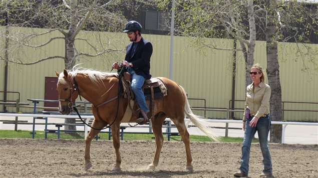 Westerner Park, Red Deer Saskatchewan. Nichols wife. Terry, is a riding instructor, here coaching a veteran. The Nichols often work with veterans who suffer from PTSD or simply have difficulty transitioning from military to civilian life. They say horses are particularly sensitive to human emotions and working with horses helps the veterans to understand how their emotions affect others and how they can learn to control their emotions.