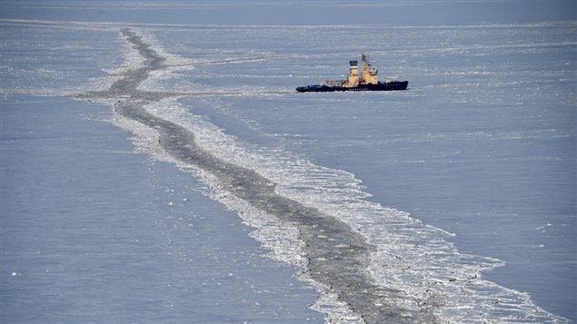 An icebreaker is seen in the back ground of a frozen Kara Sea.