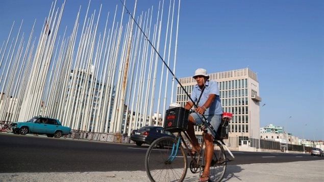 A fisherman cycles past the U.S. Interests Section building in Havana, Cuba. Since July 20, the office has been designated an embassy as Cuba-U.S. relations resume.