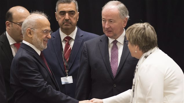 Iraq's Foreign Affairs Minister Ibrahim al-Jaafari, left, shakes hand with Kerry Buck, chief of the Canadian delegation as Foreign Affairs Minister Rob Nicholson, centre, looks on, at a meeting of the anti-ISIL Coalition Political Directors in Quebec City today