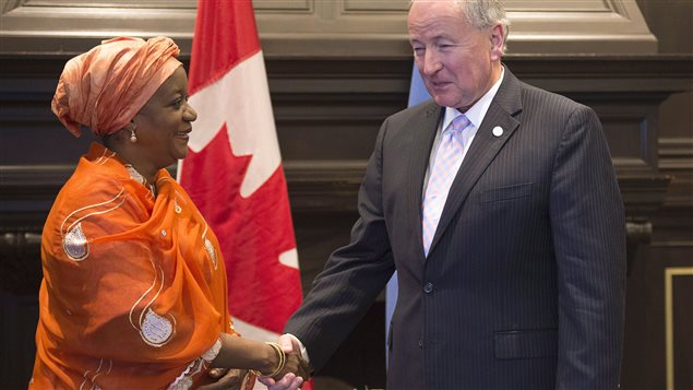 Canada's Minister of Foreign Affairs Rob Nicholson, right, and UN Special Rapporteur to the Secretary General on Sexual Violence in Conflict, Zainab Hawa Bangura shake hands at a meeting of the anti-ISIS Coalition Political Directors, Wednesday, July 29, 2015 in Quebec City
