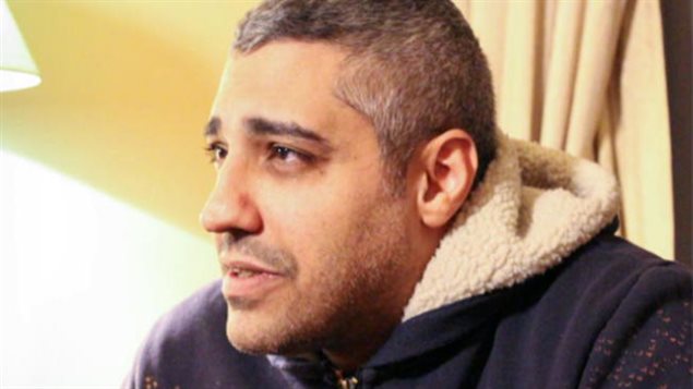 Mohamed Fahmy must wait longer for a verdict on what most say are trumped up charges. We see Mr. Fahmy sitting in a winter coat with the white fleece collar turned up at his neck. He looks forlorn. His hair is salt-and-pepper hair is cut short and he has the hint of a beard. He is looking off into the distance with sad eyes.