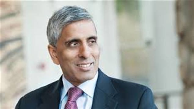 Arvind Gupta's resignation at UBC has sparked a backlash. We see a handsome East Indian man with grey hair dressed in a very sharp dark suit and tie. He appears to be listening to a question.