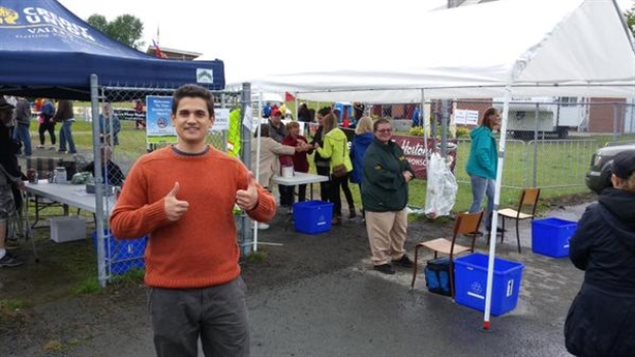 Morgan Wheeldon has left the campaign trail. We see him at some sort of fair (there are tents in the background) wearing an orange sweater and doing the thumbs up sign-thing.
