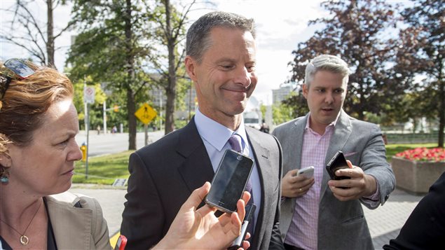 Nigel Wright, former chief of staff to Prime Minister Stephen Harper, arrives at the courthouse in Ottawa on Thursday for his second day of testimony at the Mike Duffy trial. We see Wright surrounded by three reporters, all holding smart phones, hoping to get a quote. Wright, dressed impeccably in grey suit, blue shirt and silver tie, wears on his face the grimace of a man who has realized he forgot to call his wife. The reporters are dressed--as they usually are--in sports jackets that they did not buy at Brooks Brothers.