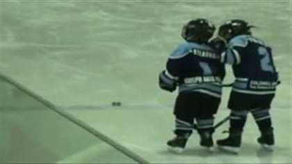 Let's face it, hockey does have its moments. We see a couple of kids, maybe three-to-five years old in full hockey uniforms with their arms around each other chasing a puck that lies a a couple of feet ahead of them.