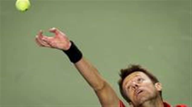 Judging by last week, Daniel Nestor's great career may be a long way from over. We see a shot of his head bent to his right with his serving arm extended up with the yellow tennis ball just having left his hand.