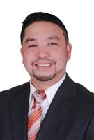 NDP candidate Mario Jacinto Rimbao. He has a lovely smile and a goatee and is dressed in a classy dark suit and tie. 