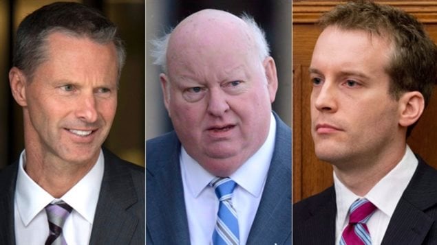 The trial of Senator Mike Duffy, centre, has heard about emails between former chief of staff Nigel Wright, left, senior aide Ray Novak, right, and other Conservative colleagues in the PMO and the Senate. We see all three from the top of the chest up. Wright has a slight smile on his face, Duffy has something of a bewildered look. Novak is seen with his chin pushed forward below a poker face.