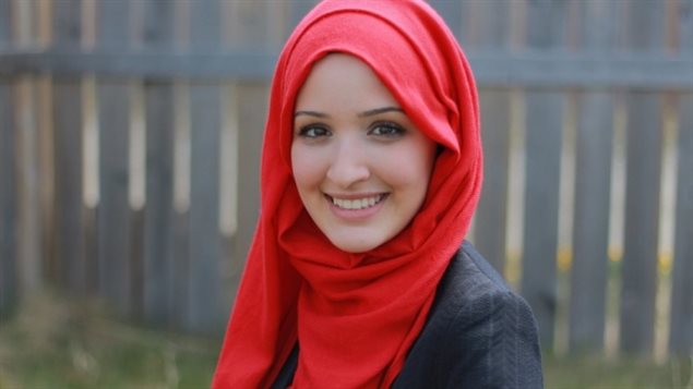 Ala Buzreba, the Liberal party candidate in Calgary-Nose Hill, apologized for offensive messages on her Twitter account as a teen and later said it was best for the riding that she step away from the race. We see a lovely young lady wearing a red hijab on her head as she smiles brightly.