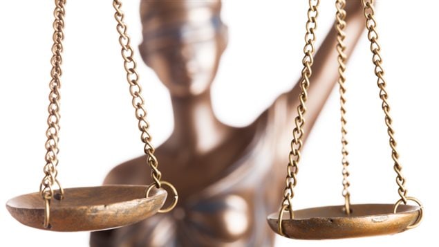 An image of lady justice holding balance scales.