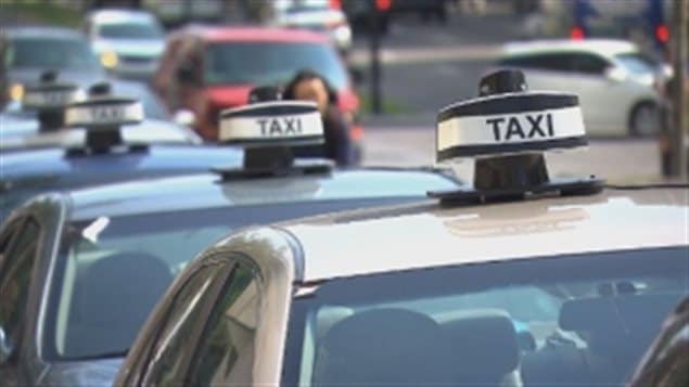 50 Taxis in a convoy made their way to the Montreal office of Premier Couillard today, protesting the growth of the ride-sharing service, UberX, in the province.