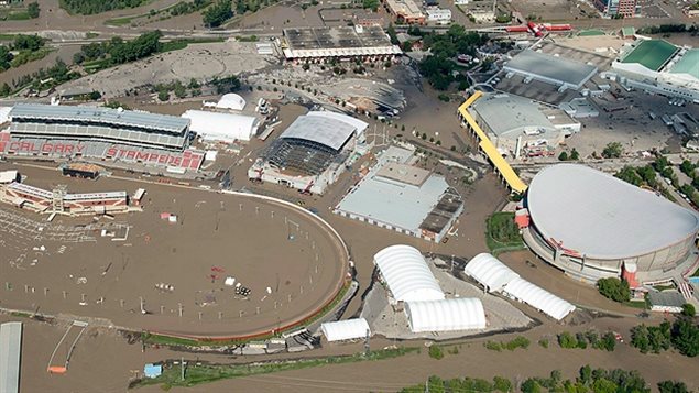 Jul 2013 Muddy brwon water has flooded Calgary Stampede stadium and Saddledome are seen at the height of the flooding of the city.