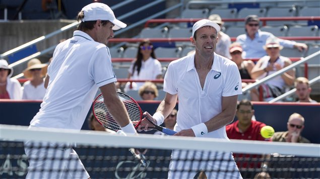 Daniel Nestor, right, and Edouard Roger-Vasselin of France, have been hot this month. Can they carry it forward at the U.S. Open that begins Monday? We see both men tall and lean and dressed in whites, including white hats, at the net. Nestor, a lefty is in a backhand pose while Roger-Vasselin, a righty, holds a similar pose. In other words, they have the middle of the court completely covered.
