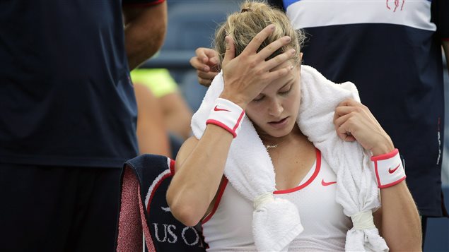 Eugenie Bouchard, of Canada, takes a break between games against Dominika Cibulkova, of Slovakia, during the third round of the U.S. Open tennis tournament, Friday, Sept. 4, 2015, in New York. Bouchard has now withdawn from the U.S. Open with a concussion suffered Friday night.